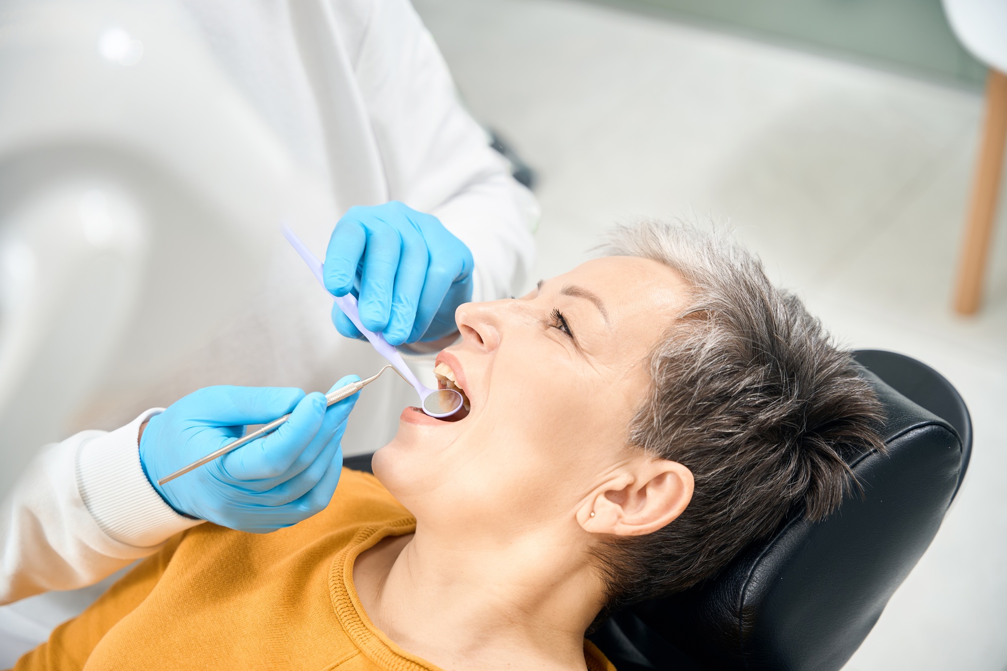 Dental therapist conducting dental examination of oral cavity